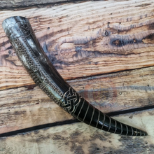 viking horn resting on planks of wood